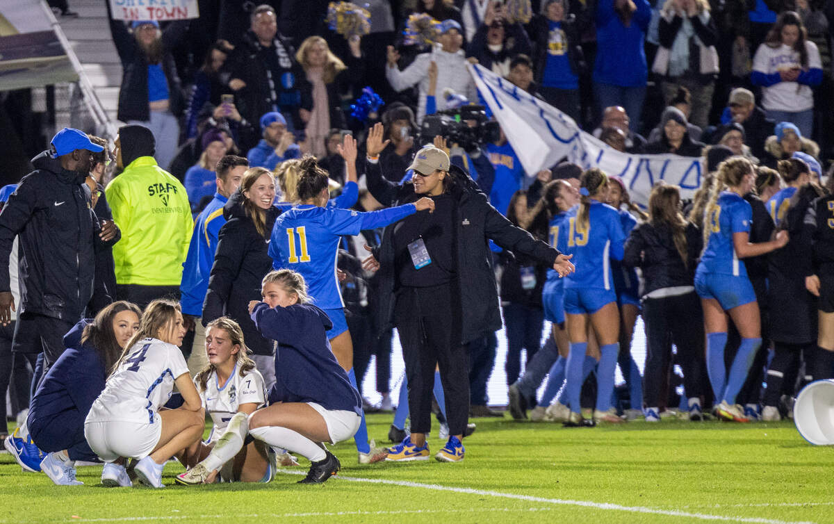 Dejected UNC players comfort each other after losing 3-2 in overtime against UCLA during the NCAA Division I Championship at WakeMed Soccer Park in Cary Monday, Dec. 5, 2022.
