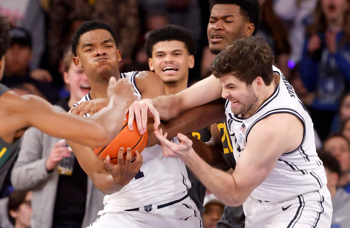 Duke’s Caleb Foster (1) and Ryan Young (15) pull in a rebound from Baylor’s Yves Missi (21) during the second half of Duke’s 78-70 victory over Baylor at Madison Square Garden in New York City Wednesday, Dec. 20, 2023.