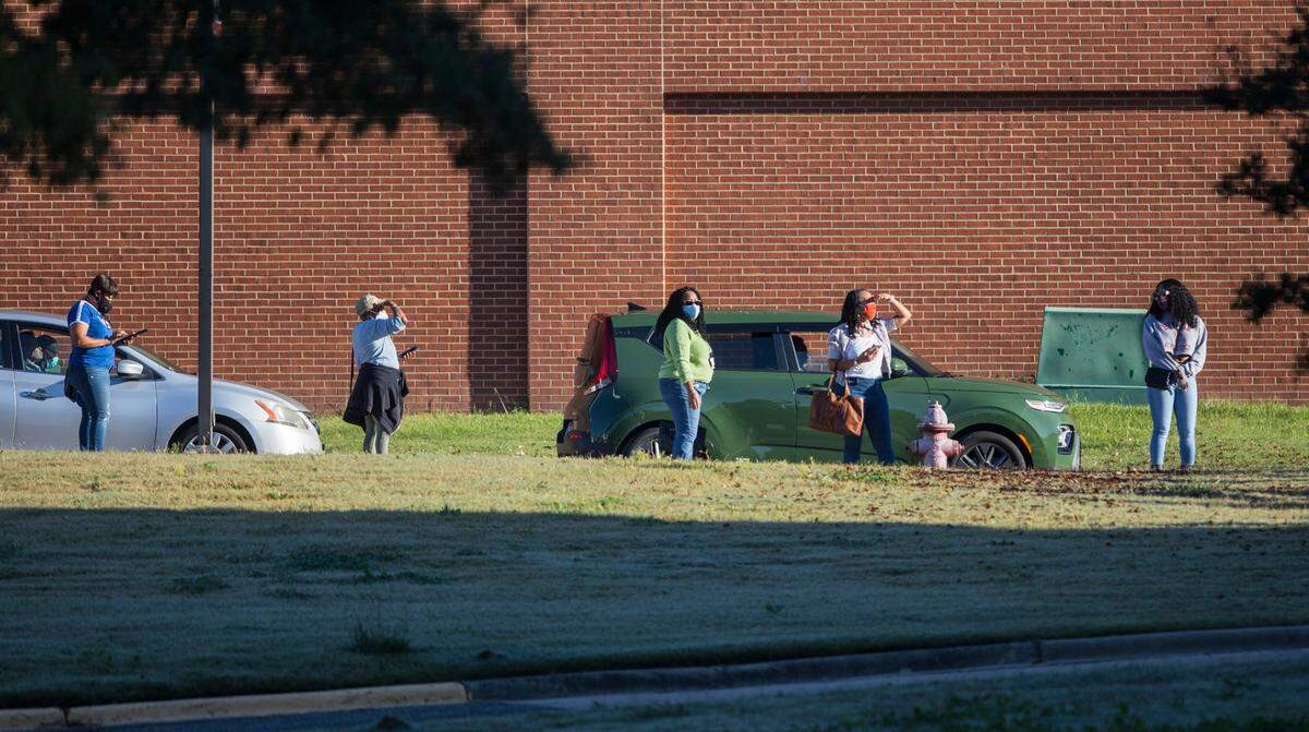 Durham County voters stand in line outside the Turner Law Building at N.C. Central University in Durham, N.C. on the first day of early voting, Thursday, Oct. 15, 2020.