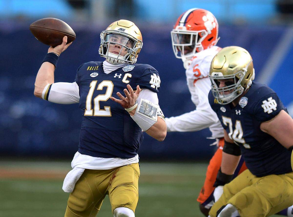 Notre Dame quarterback Ian Book drops back to pass to a receiver during first quarter action against Clemson at Bank of America Stadium on Saturday, December 19, 2020 in Charlotte, NC. The Clemson Tigers and Notre Dame Fighting Irish faced off in the ACC Championship game.