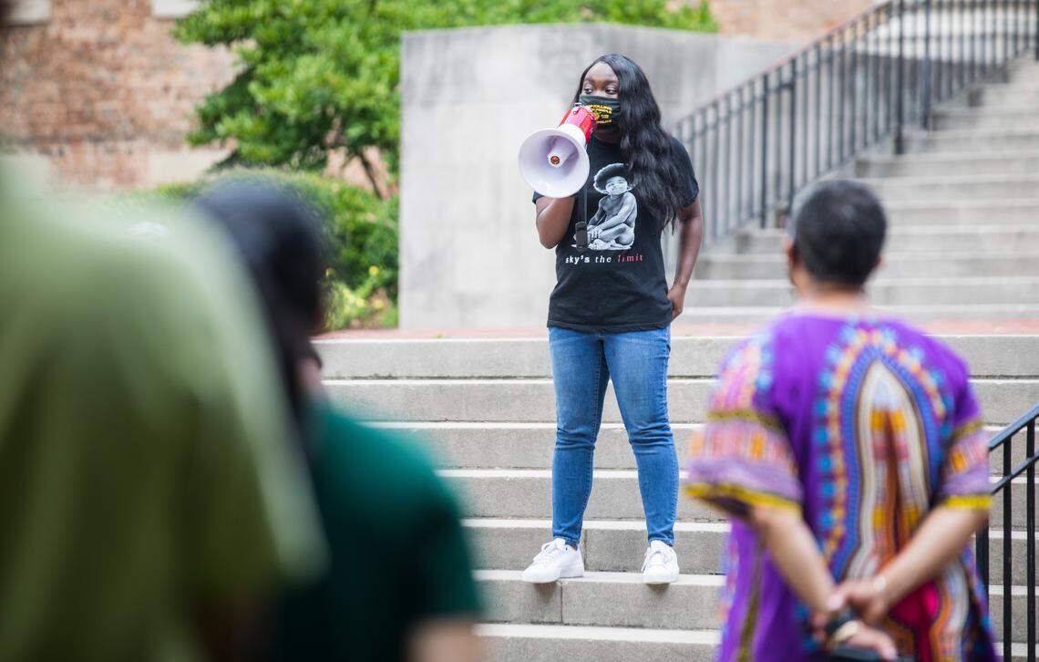 Jarrah Faye, president of the UNC-Chapel Hill chapter of the NAACP, speaks to a small crowd about recent events regarding the tenure of Nikole Hannah-Jones and far-right demonstrations on campus, outside South Building in Chapel Hill, N.C. on Monday, July 12, 2021.