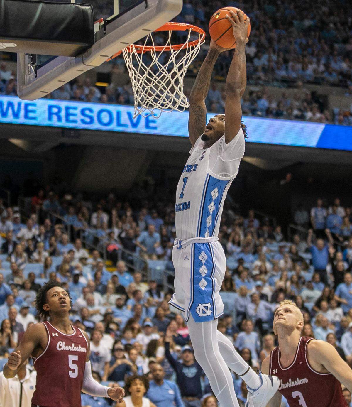 North Carolina’s Leaky Black (1) gets a dunk over College of Charleston’s Raekwon Horton (5) and Dalton Bolon (3) during the second half on Friday, November 11, 2022 at the Smith Center in Chapel Hill, N.C. Black scored 15 points.