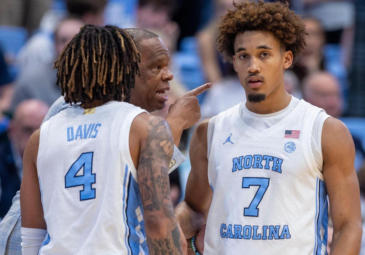North Carolina coach Hubert Davis instructs guards R.J. Davis (4) and Seth Trimble (7) in the second half against Georgia Tech on Saturday, December 7, 2024 at the Smith Center in Chapel Hill, N.C.