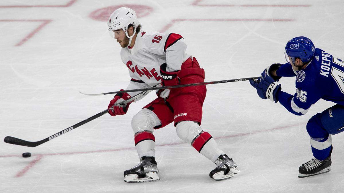 Carolina Hurricanes’ Dylan Coghlan (15) controls the puck ahead of Tampa Bay’s Cole Kopek (45) during the second period of an NHL preseason game against Tampa Bay on Tuesday, September 27, 2022 at PNC Arena in Raleigh, N.C.