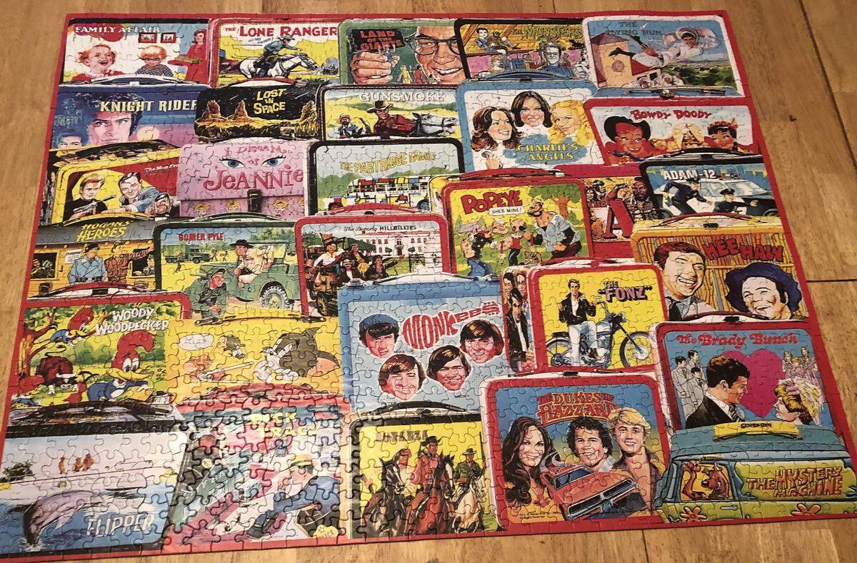 A 1,000-piece puzzle of various TV-themed lunchboxes.