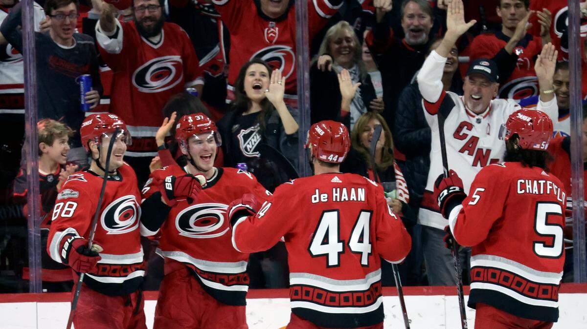 Carolina Hurricanes right wing Andrei Svechnikov, second from left, celebrates his third goal of the game with center Martin Necas (88), defenseman Calvin de Haan (44) and defenseman Jalen Chatfield (5) during the third period of an NHL hockey game against the Edmonton Oilers, Thursday, Nov. 10, 2022, in Raleigh, N.C. (AP Photo/Chris Seward)