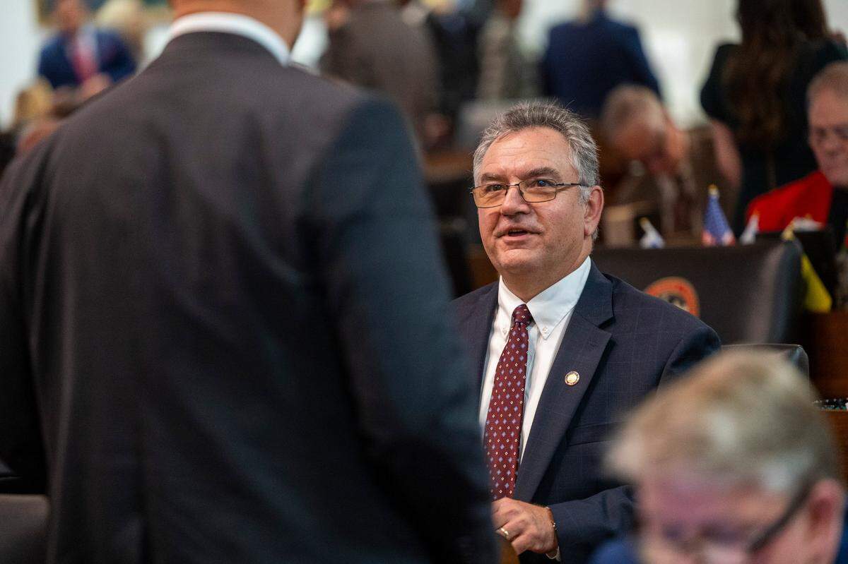State Rep. Karl Gillespie, a Franklin Republican and the House majority whip, speaks to a colleague on the House floor on Wednesday, Dec. 11, 2024.