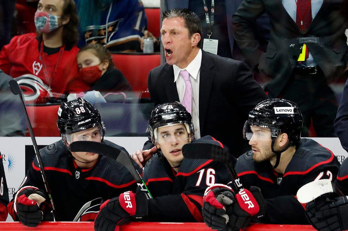 Carolina Hurricanes head coach Rod Brind”Amour, top center, protests a call with the official during the third period of an NHL hockey game against the Washington Capitals in Raleigh, N.C., Sunday, Nov. 28, 2021. (AP Photo/Karl B DeBlaker)