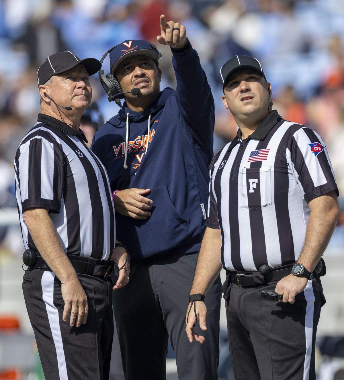 Virginia head coach Tony Elliott confers with officials as they review a play in the first quarter against North Carolina on Saturday, October 25, 2025 at Kenan Stadium in Chapel Hill, N.C. 