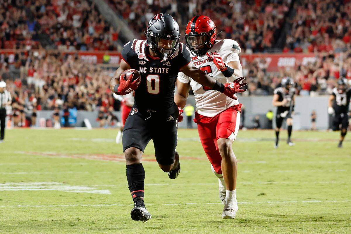 N.C. States Demie Sumo-Karngbaye (0) beats Texas Tech defensive back Kosi Eldridge (6) to score on a 38-yard touchdown reception from Thayer Thomas during the second half of N.C. States 27-14 victory over Texas Tech at Carter-Finley Stadium in Raleigh, N.C., Saturday, Sept. 17, 2022.