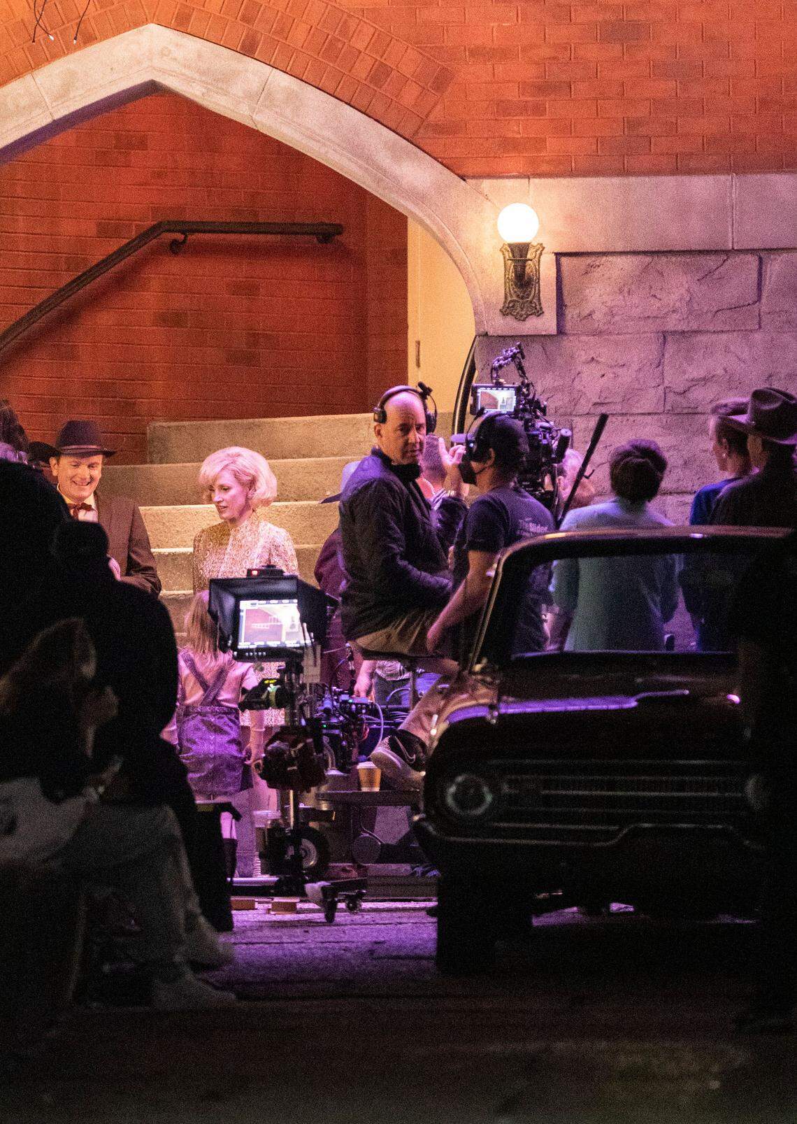 A production crew films a scene for “George and Tammy,” a television series about country music stars George Jones and Tammy Wynette, played by Michael Shannon and Jessica Chastain, far left, in downtown Wilmington, N.C. on Friday, March 18, 2022.