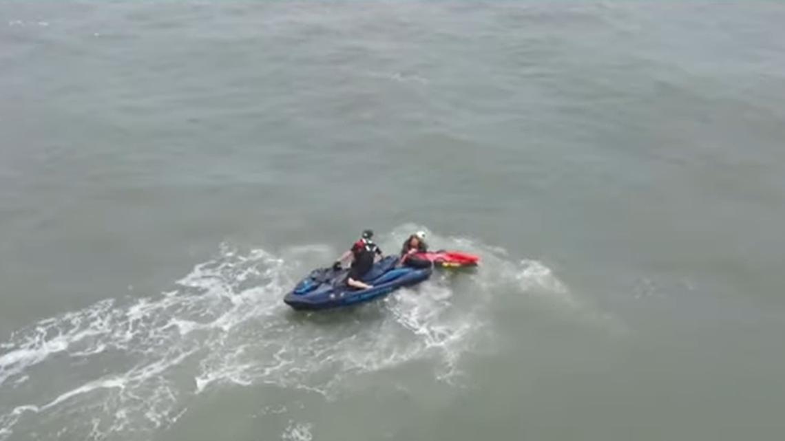 The person was carried to shore and then taken to a waiting ambulance, video shows.