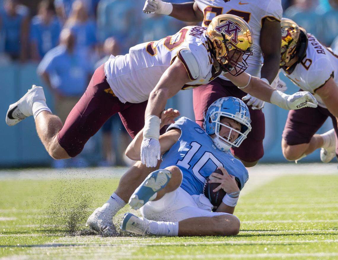 North Carolina quarterback Drake Maye (10) slides under Minnesota’s Danny Striggow (92) after a gain of six yards in the second quarter on Saturday, September 16, 2023 at Kenan Stadium in Chapel Hill N.C.