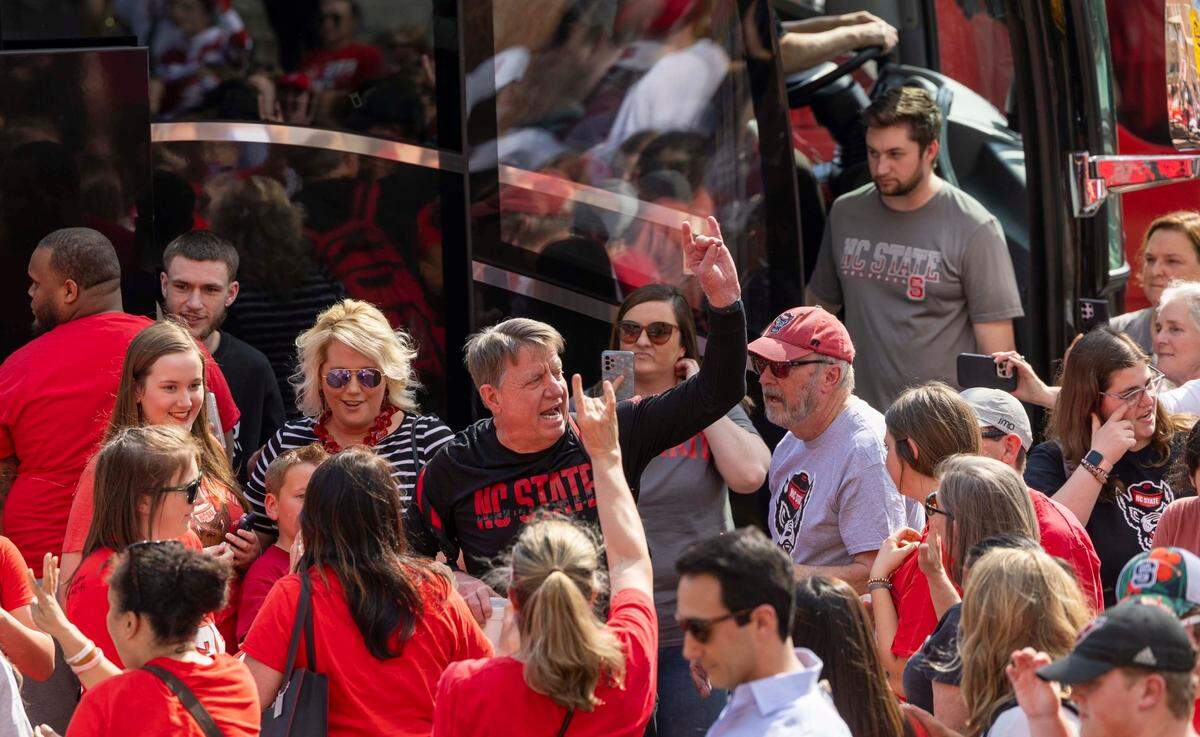 NC State’s women’s head basketball coach Wes Moore is greeted by fans on Tuesday, April 2, 2024 while boarding a bus outside Reynolds Coliseum bound for the Final Four game on Friday.