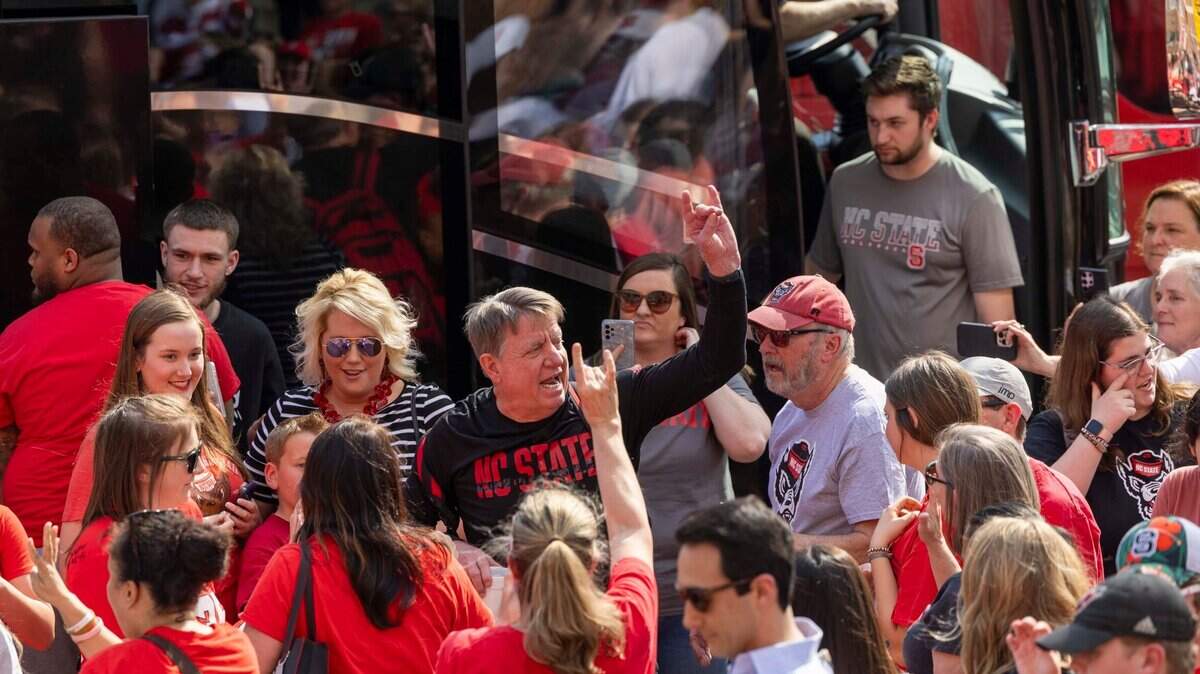 NC State’s women’s head basketball coach Wes Moore is greeted by fans on Tuesday, April 2, 2024 while boarding a bus outside Reynolds Coliseum bound for the Final Four game on Friday.