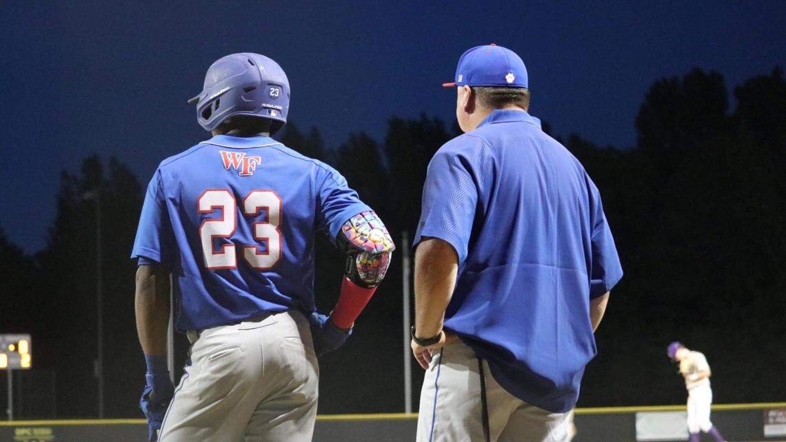 Wake Forest High School shortstop Kahlil Watson waits on deck with coach Mike Joyner