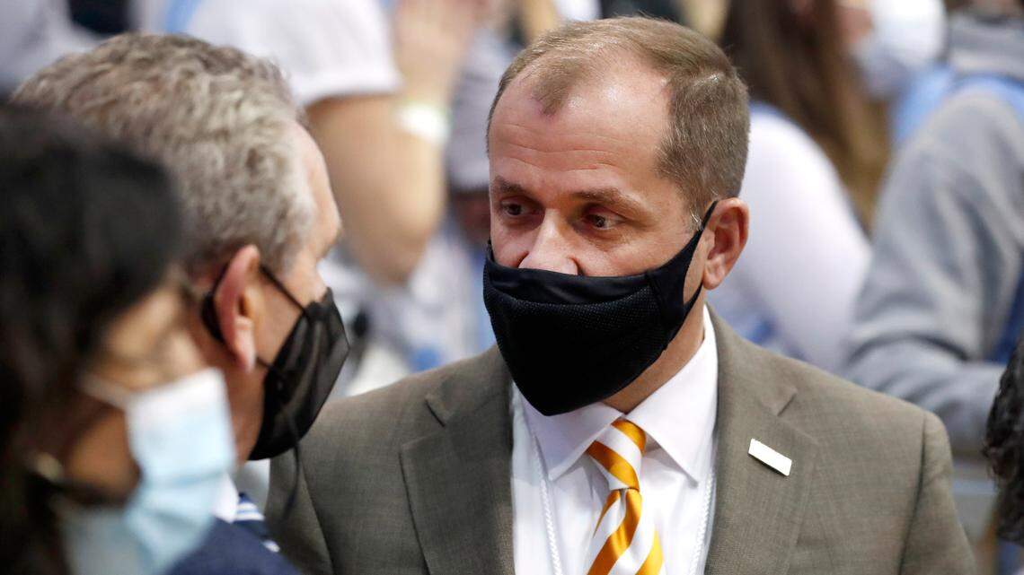 ACC Commissioner Jim Phillips talks with North Carolina athletic director Bubba Cunningham before UNC’s game against Boston College at the Smith Center in Chapel Hill, N.C., Wednesday, Jan. 26, 2022.
