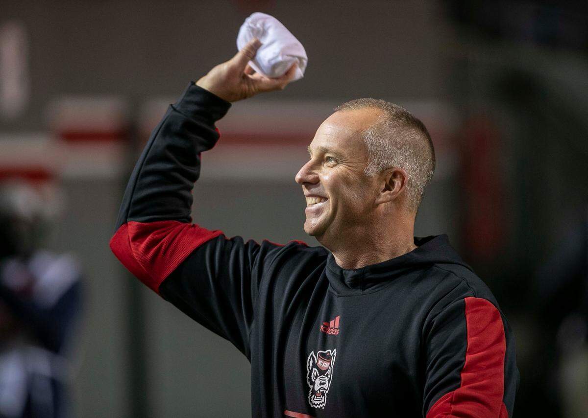 N.C. State coach Dave Doeren tosses t-shirts into the student section prior to the Wolfpack’s game against North Carolina on Friday, November 26, 2021 at Carter-Finley Stadium in Raleigh, N.C.