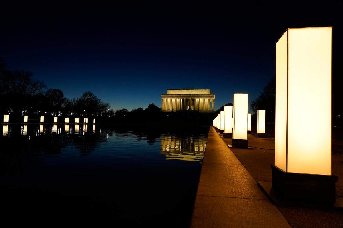 Lights surround the Lincoln Memorial Reflecting Pool, placed as a memorial to COVID-19 victims Tuesday, Jan. 19, 2021, in Washington, after President-elect Joe Biden spoke, with Lincoln Memorial in the background.