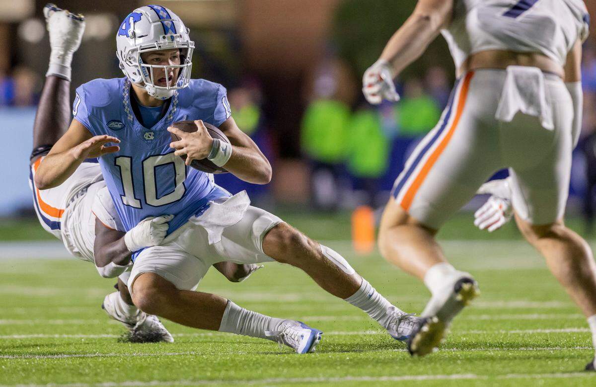 North Carolina quarterback Drake Maye (10) is sacked by Virginia’s Ben Smiley III (10) for a two yard loss in the fourth quarter on Saturday, October 21, 2023 at Kenan Stadium in Chapel Hill, N.C.