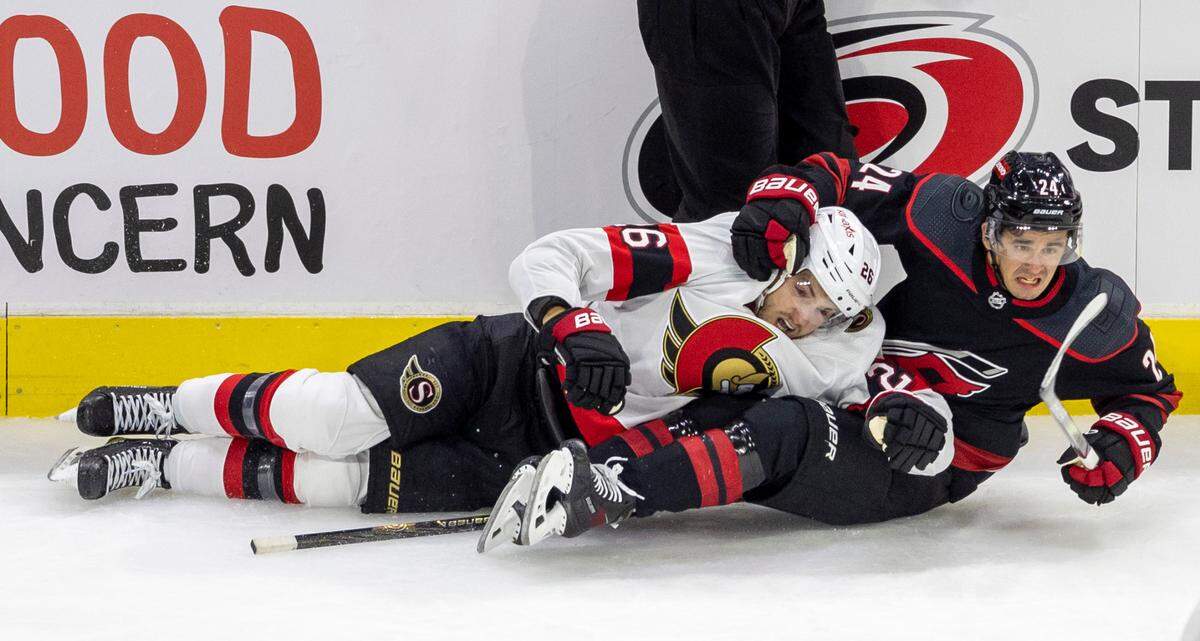 The Ottawa Senators Erik Brannstorm (26) gets tangled with the Carolina Hurricanes Seth Jarvis (24) in the second period on Wednesday, October 11, 2023 at PNC Arena, in Raleigh N.C.