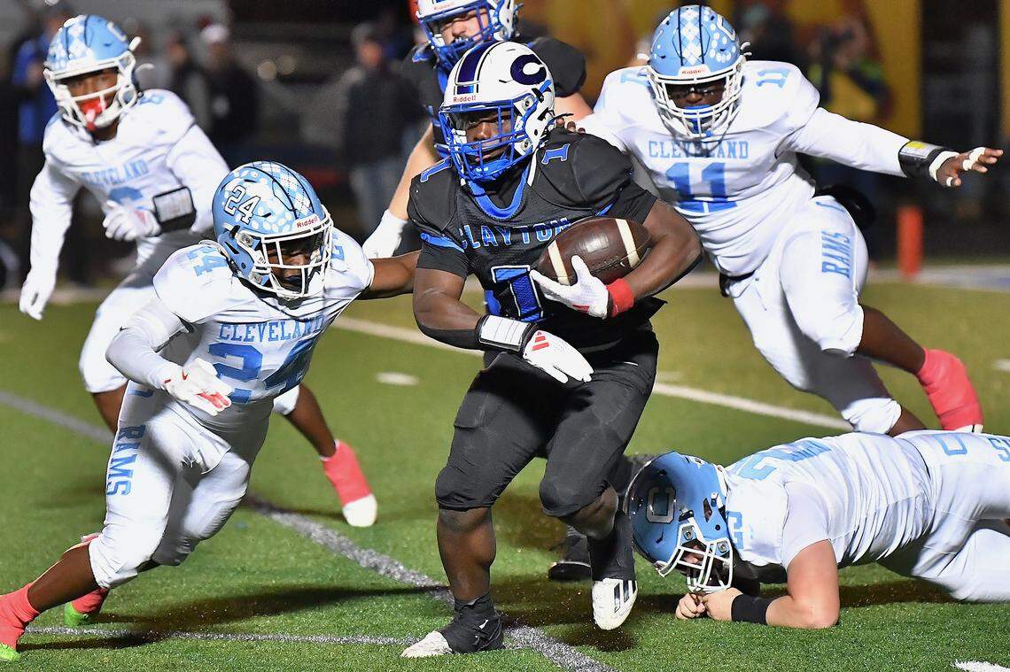 Clayton running back Noah Smith (1) runs for yardage against the Cleveland defense during the first half. The Cleveland Rams took on the Clayton Comets in a conference football game in Clayton, N.C. on October 31st in Clayton, N.C.