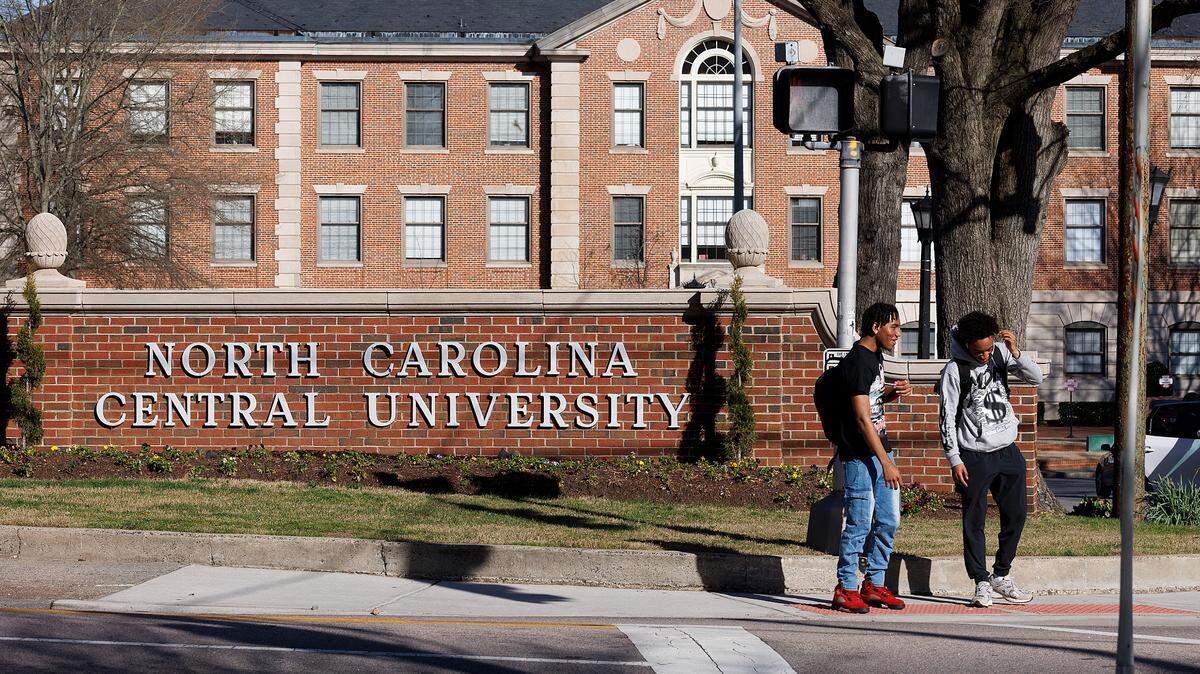 People wait to cross Fayetteville Street on the campus of North Carolina Central University on Tuesday, March 12, 2024, in Durham, N.C.