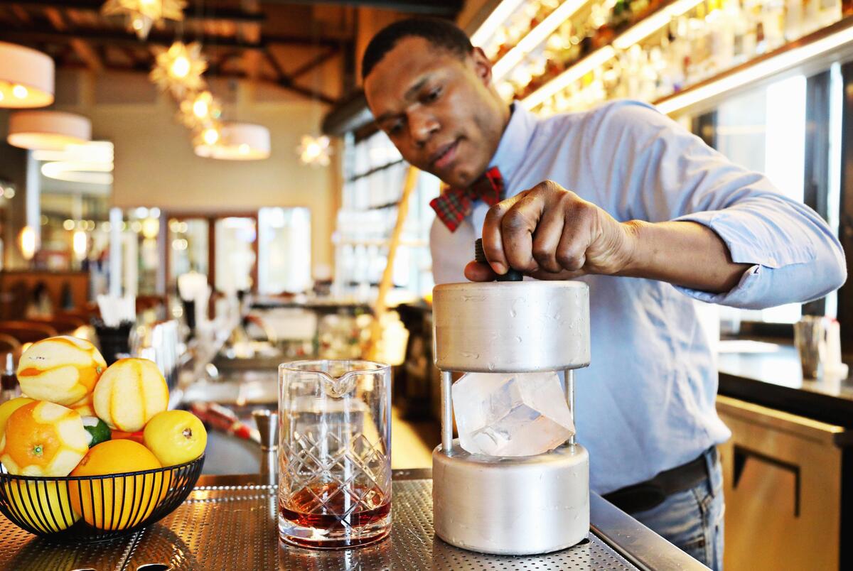 STIR bartender Isaiah Charite adds a two-inch cube to a mold to create a perfect sphere of ice for the barrel-aged Vieux Carré at the North Hills restaurant on Wednesday, Feb. 5, 2020.