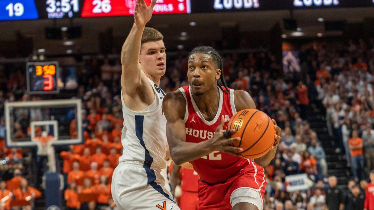 Houston guard Tramon Mark (12) move past a Virginia defender during the first half of an NCAA college basketball game in Charlottesville, Va., Saturday, Dec. 17, 2022. (AP Photo/Erin Edgerton)