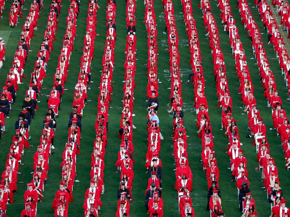 N.C. State graduates sit on the field at Carter-Finley Stadium during the Wolfpack’s commencement ceremonies for the class of 2021 at the stadium in Raleigh, N.C., Friday, May 14, 2021.