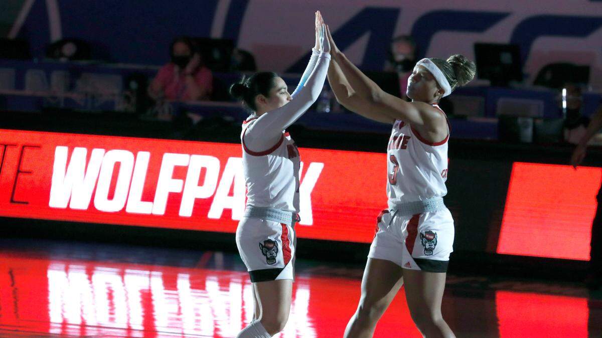 N.C. State’s Kai Crutchfield (3), right, greets Raina Perez (2) during pregame introductions before N.C. State’s game against Virginia Tech in the quarterfinals of the ACC Women’s Basketball Tournament in Greensboro, N.C., Friday, March 5, 2021.