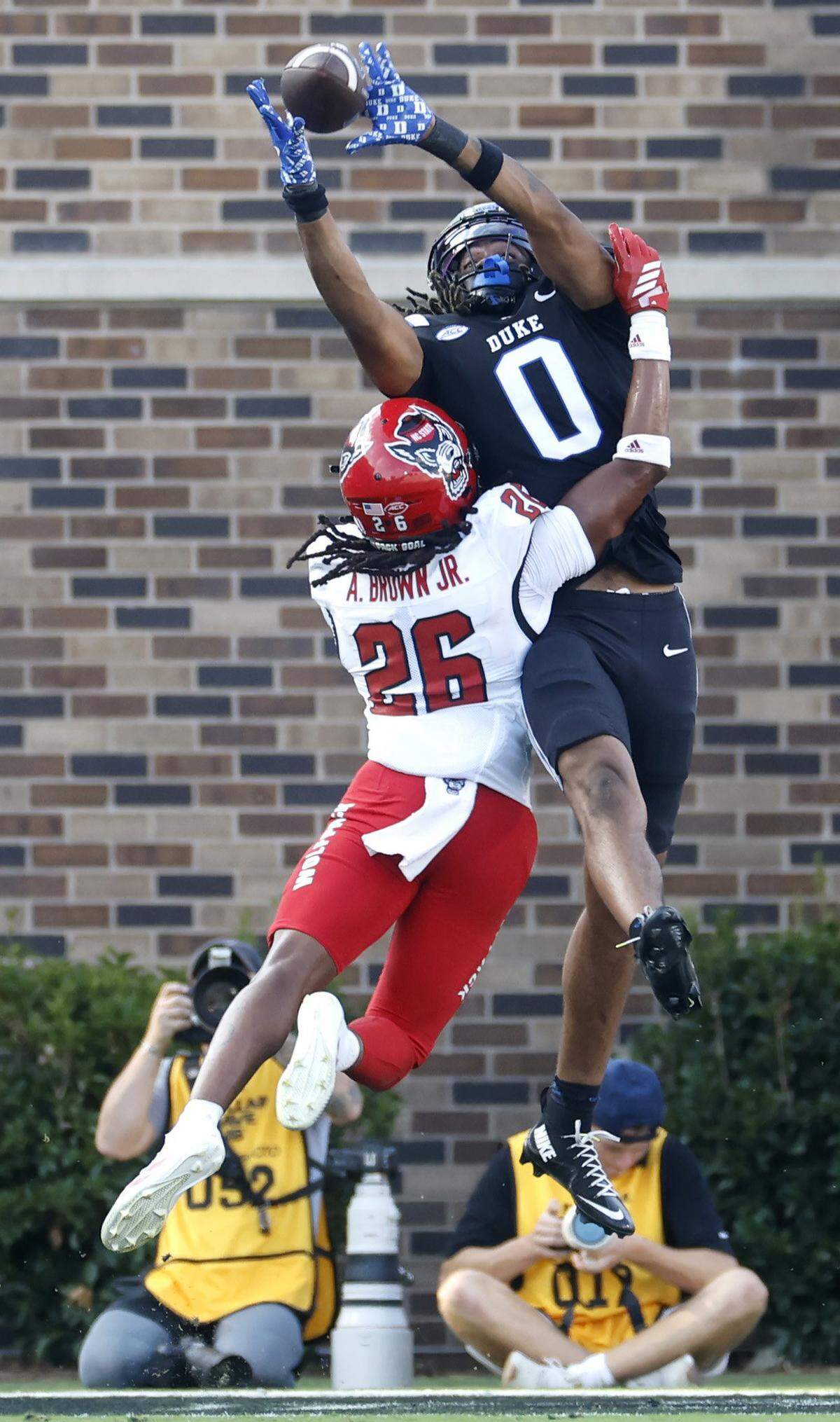 Duke tight end Landen King (0) pulls in the touchdown reception while being defended vy N.C. State defensive back Asaad Brown Jr. (26) during the first half of N.C. State’s game against Duke at Wallace Wade Stadium in Durham, N.C., Sat. Sept. 20, 2025