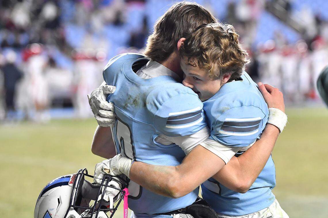 Watauga's Cade Keller (10) and Evan Burroughs (12) embrace and celebrate their impending victory over Middle Creek in the NCHSAA 6A Football Championship. The Middle Creek Mustangs and the Watauga Pioneers met in the NCHSAA 6A Football Championship game in Chapel Hill, N.C. on December 12, 2025. 