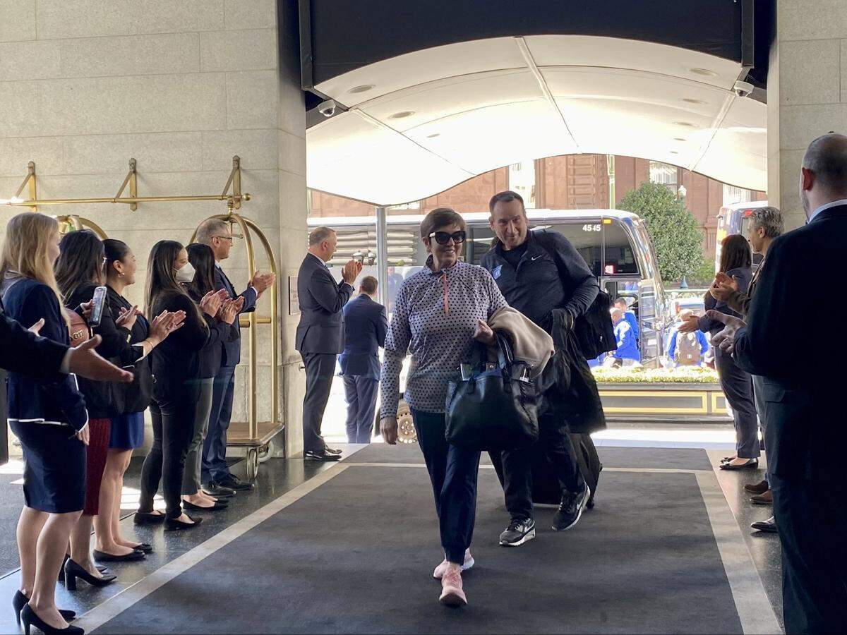 Duke basketball coach Mike Krzyzewski, back, follows his wife, Mickie Krzyzewski, into the Fairmont hotel in San Francisco as the team arrives for the NCAA tournament’s West Regional on Tuesday.