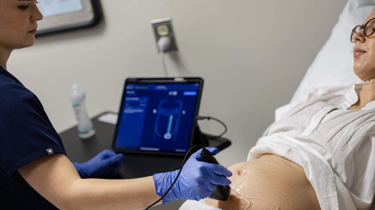 Jenny Teague demonstrates UNC’s new ultrasound technology on a pregnant woman.