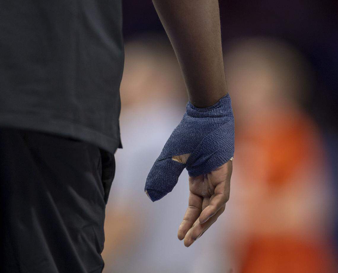 North Carolina forward Caleb Wilson, out with a broken thumb, wears a large bandage on his injured hand, as his teammates warm up for their ACC Tournament game against Clemson, on Thursday, March 12, 2026 at Spectrum Center in Charlotte, N.C.