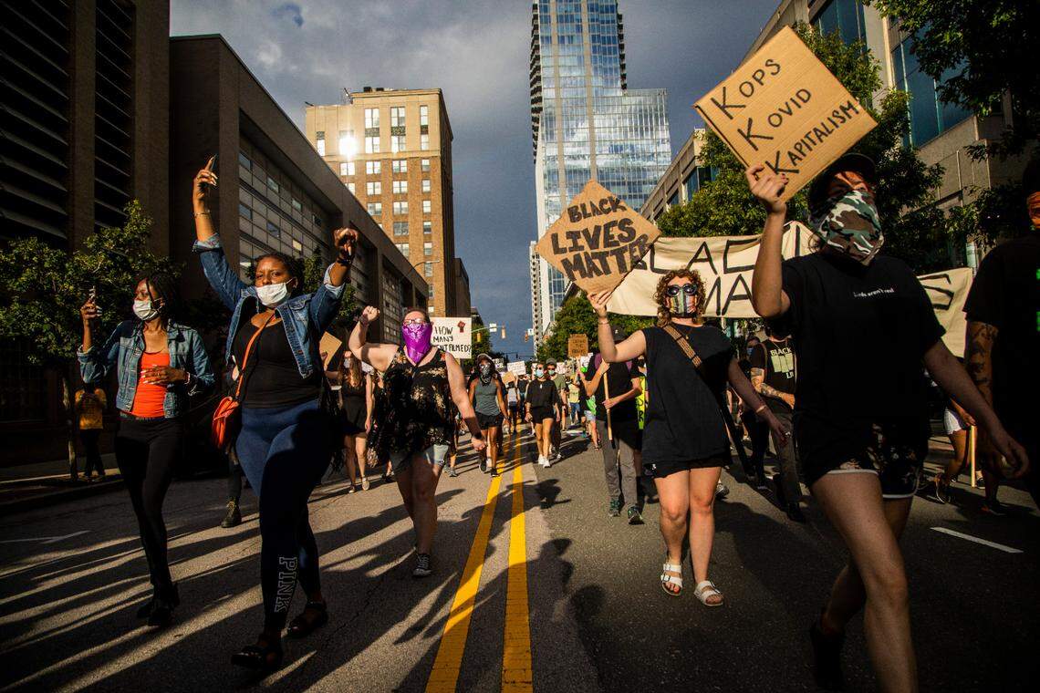 About 100 protesters calling for police reform and an end to systemic racism march on West Martin Street in Raleigh Sunday, June 14, 2020.