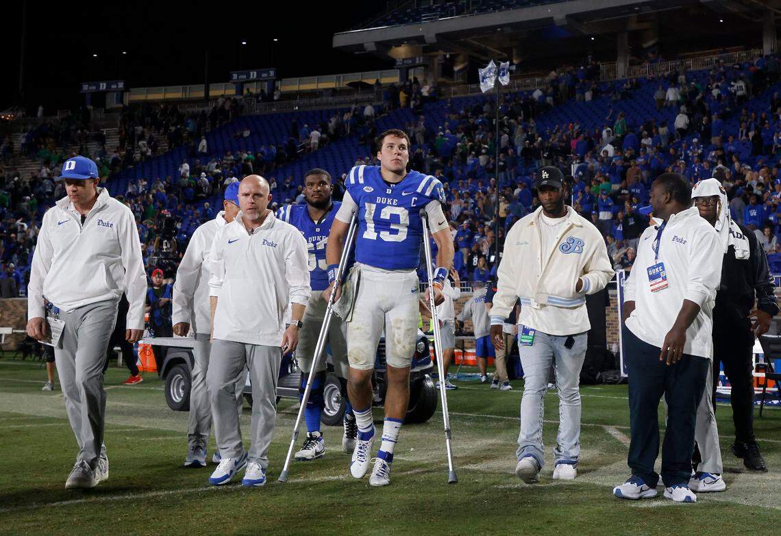 Duke’s Riley Leonard leaves the field on crutches following the Blue Devils’ 21-14 loss to Notre Dame at Wallace Wade Stadium on Saturday, Sept. 30, 2023, in Durham, N.C.