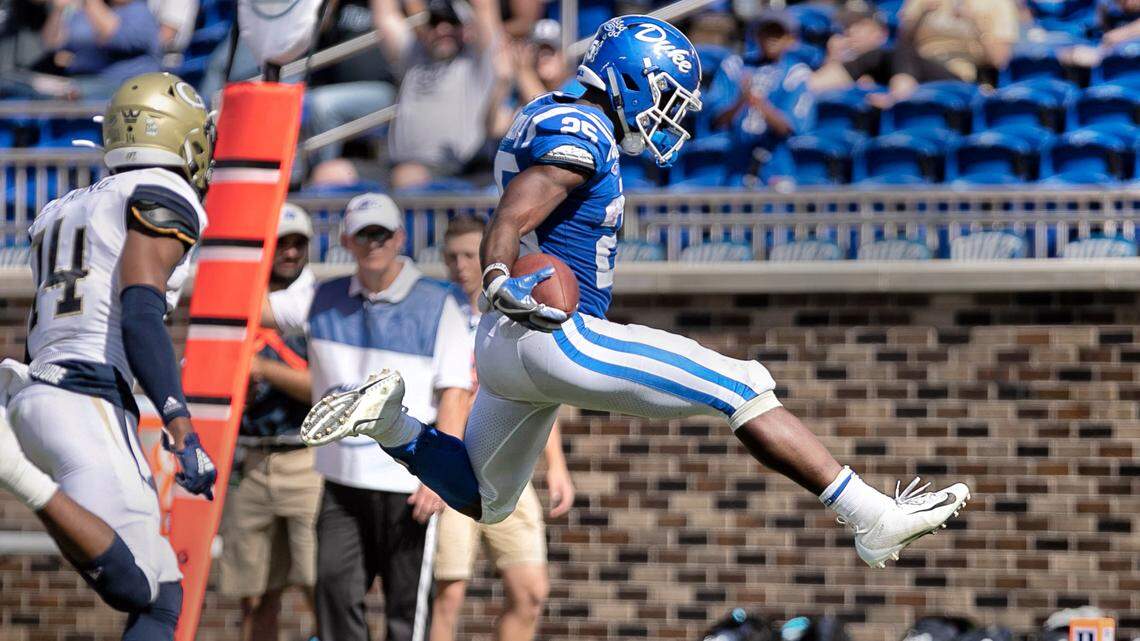 Duke’s Deon Jackson (25) hurdles into the end zone on a seven yard rush for a touchdown down ahead of Georgia Tech’s Jaylon King (14) to give the Blue Devils’ a 31-7 lead in the second quarter on Saturday October 12, 2019 at Wallace Wade Stadium in Durham, N.C.