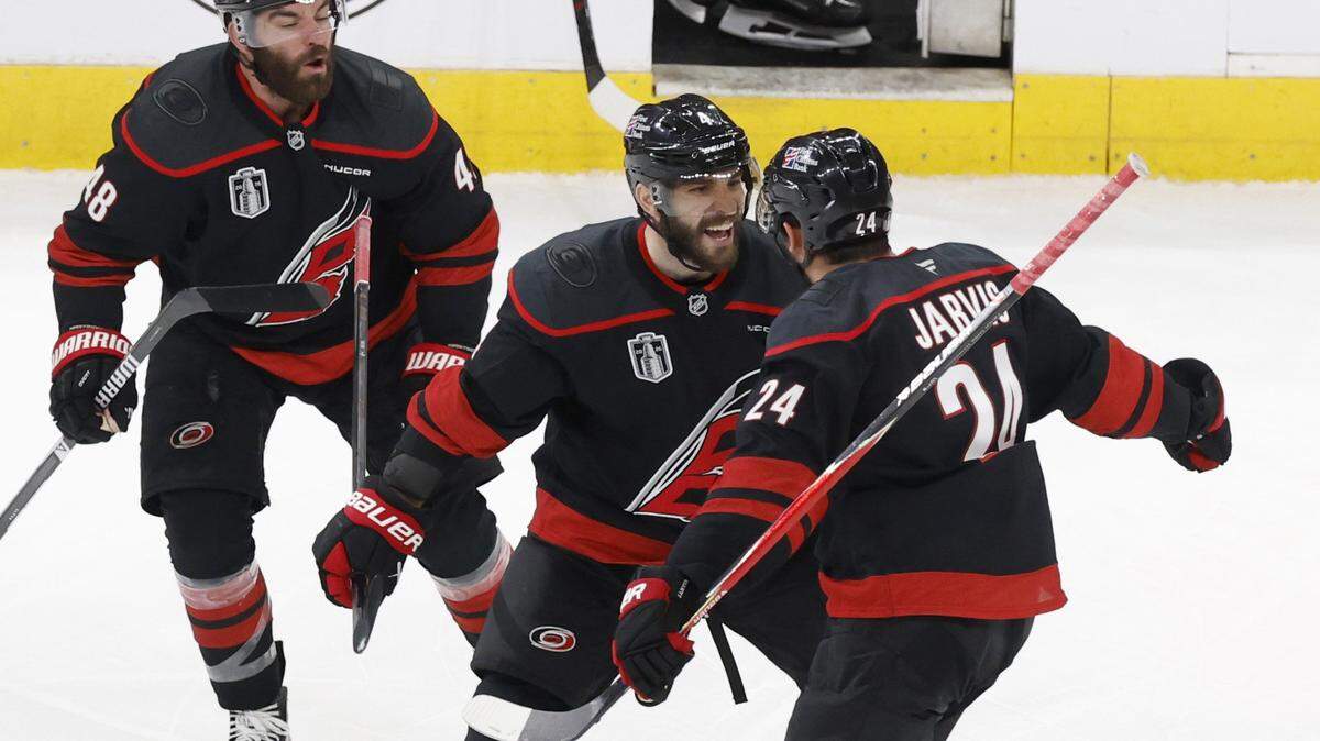 Carolina's Shayne Gostisbehere (4) celebrates with Seth Jarvis (24) after he scored in overtime of the Hurricanes’ 4-3 victory over the Golden Knights in the second game of the Stanley Cup Final at the Lenovo Center in Raleigh, North Carolina, on Thursday, June 4, 2026.