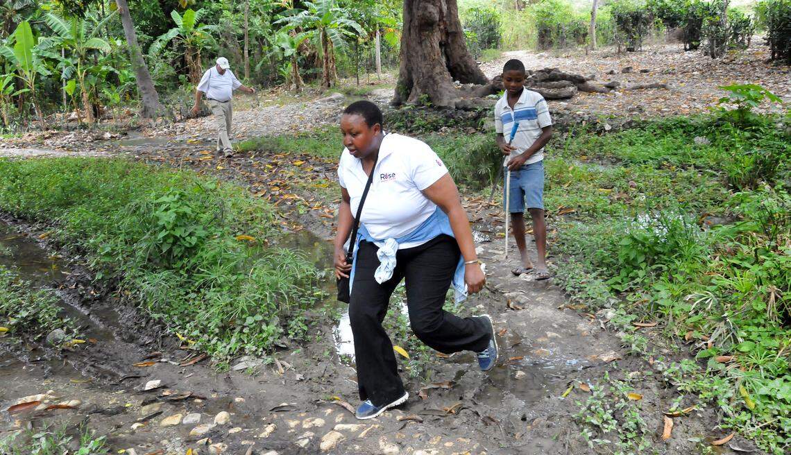 Edna Ogwangi hikes to see a spring that the Haitians call "Madame Charles." It's a principal water source for the area.