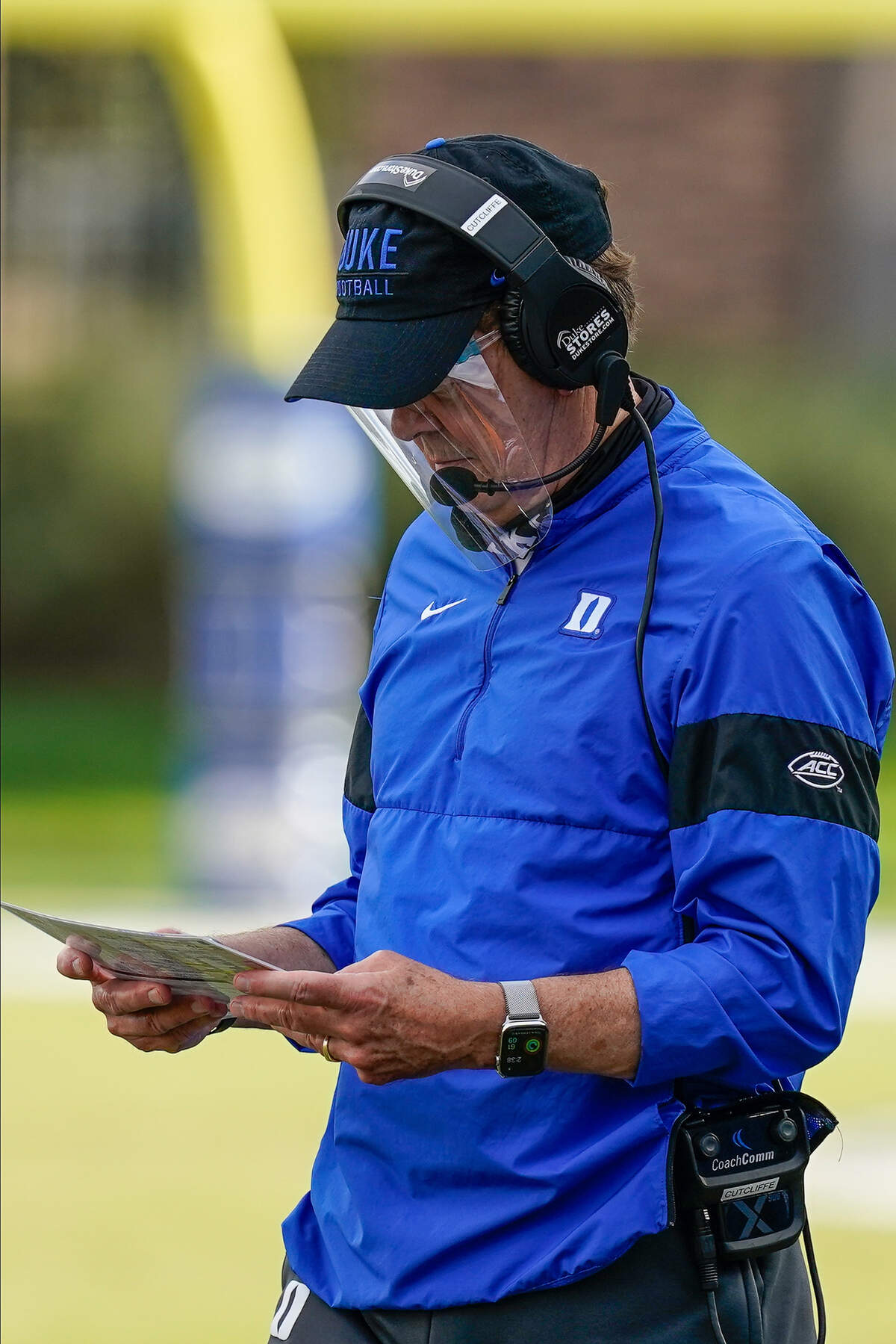 Duke Blue Devils head coach David Cutcliffe looks over a play card during a timeout against the North Carolina Tar Heels during the second half at Wallace Wade Stadium.
