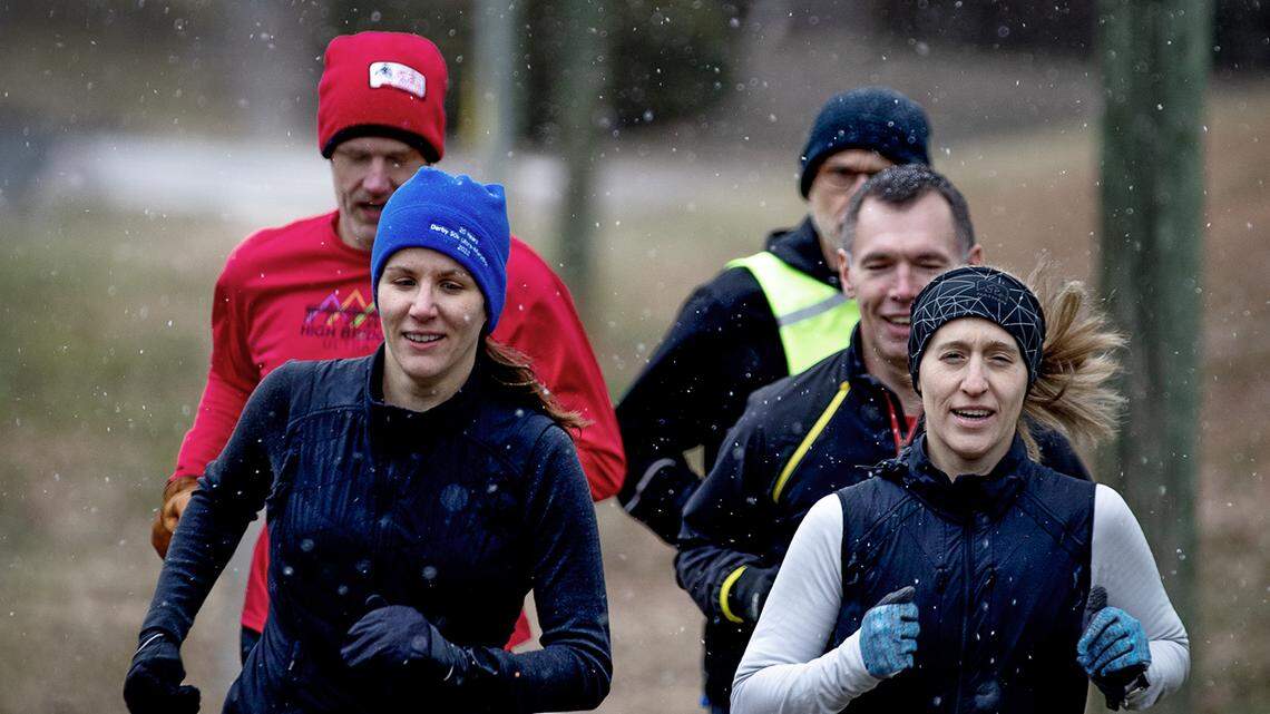 Members of the Pittsboro Run Club head south out of town on their Friday afternoon noon as snow begins to fall, Jan. 19, 2025.