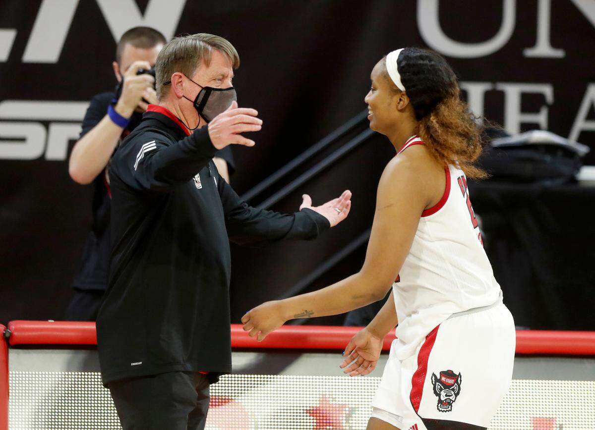 N.C. State’s Kayla Jones (25) heads to hug coach Wes Moore as she is recognized while coming off the court at the end of N.C. State’s 83-53 victory over Pittsburgh at Reynolds Coliseum in Raleigh, N.C., Thursday, February 25, 2021.