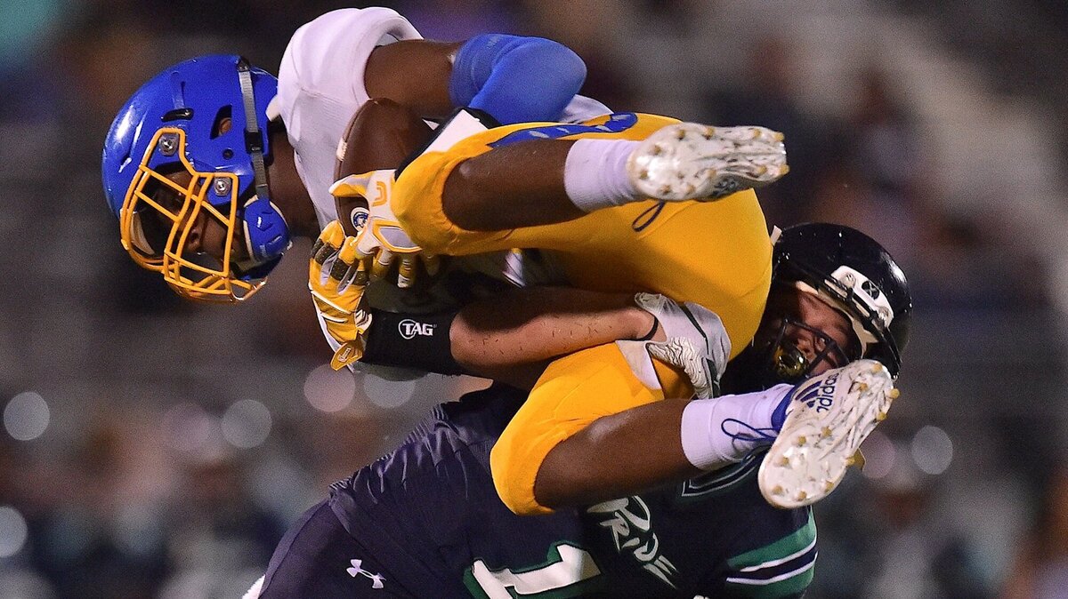 Leesville Road’s David Sohn (1)  lifts and tackles Garner Magnet’s Darius Boone. The Leesville Road Pride and the Garner Trojans met in a non-conference football game in Raleigh, N.C. on September 12, 2018. Leesville Road won 26-24.
