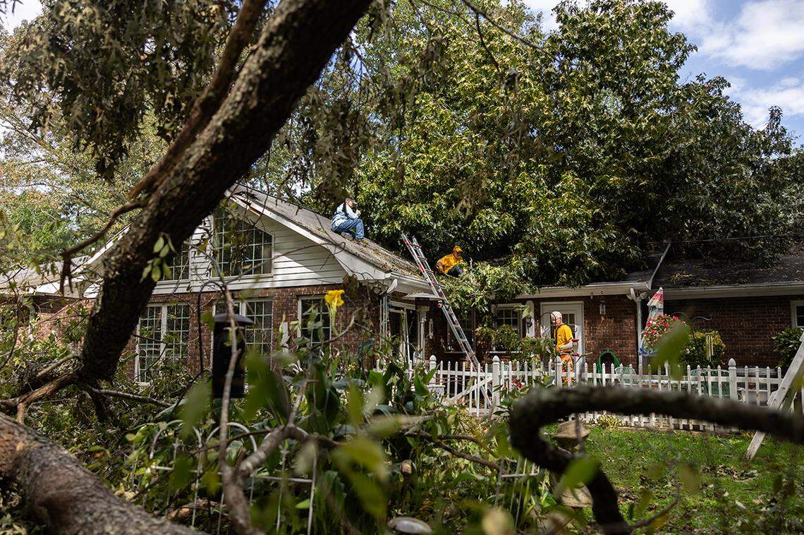 John Miller, from left, Craig Schomburg and Mark Cantrell with NC Baptists on Mission Disaster Relief remove trees from Bill White’s home in Arden, N.C. on Monday, September 30, 2024.