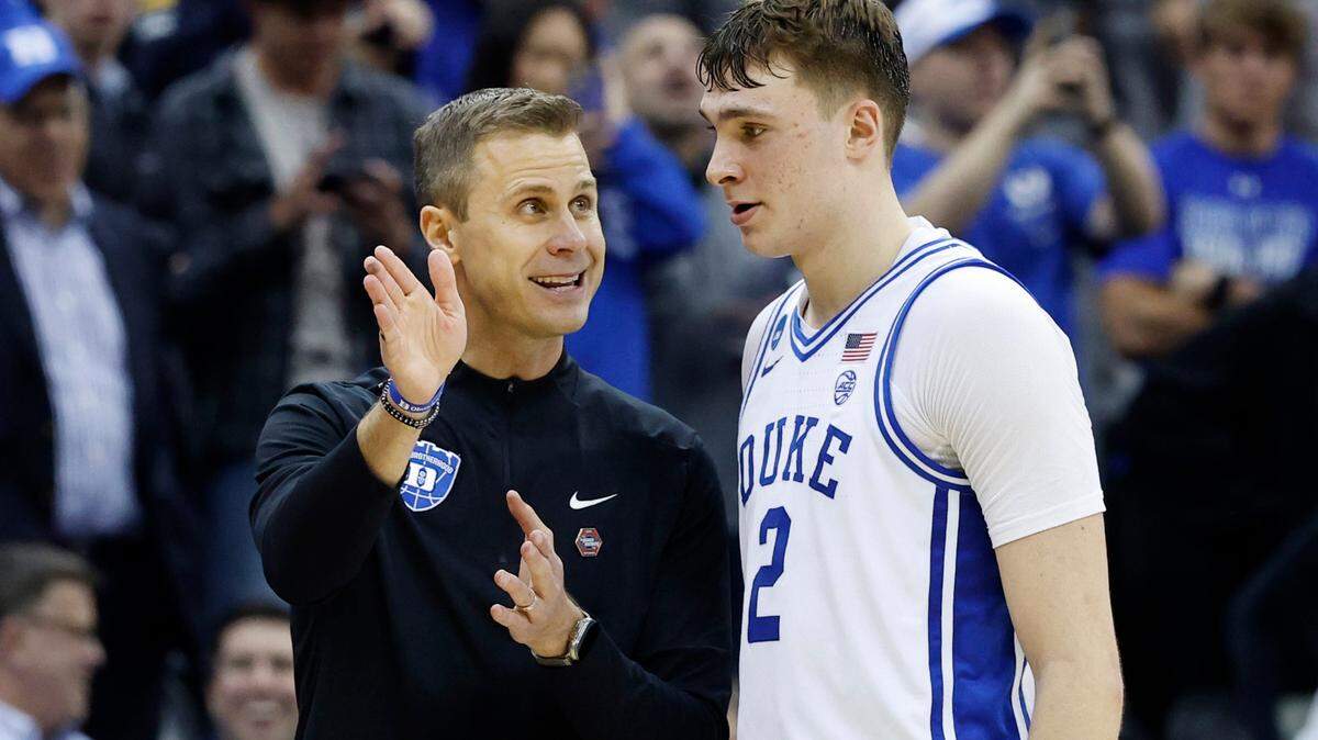 Duke head coach Jon Scheyer talks with Cooper Flagg (2) during victory over Arizona in the Sweet 16 round of the 2025 MenÕs NCAA Basketball Championship in March 2025. Duke is using the lessons of Cooper FlaggÕs season to teach players how to handle their new outside responsibilities.