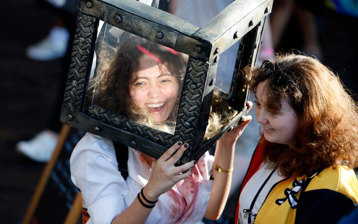 Tshering Blackwell, left, laughs with Alex Barnwell at GalaxyCon Raleigh at the Raleigh Convention Center Saturday, July 27, 2024. Blackwell is dressed as Peter Strahm from Saw and Barnwell is dressed from Lego Monkie Kid.