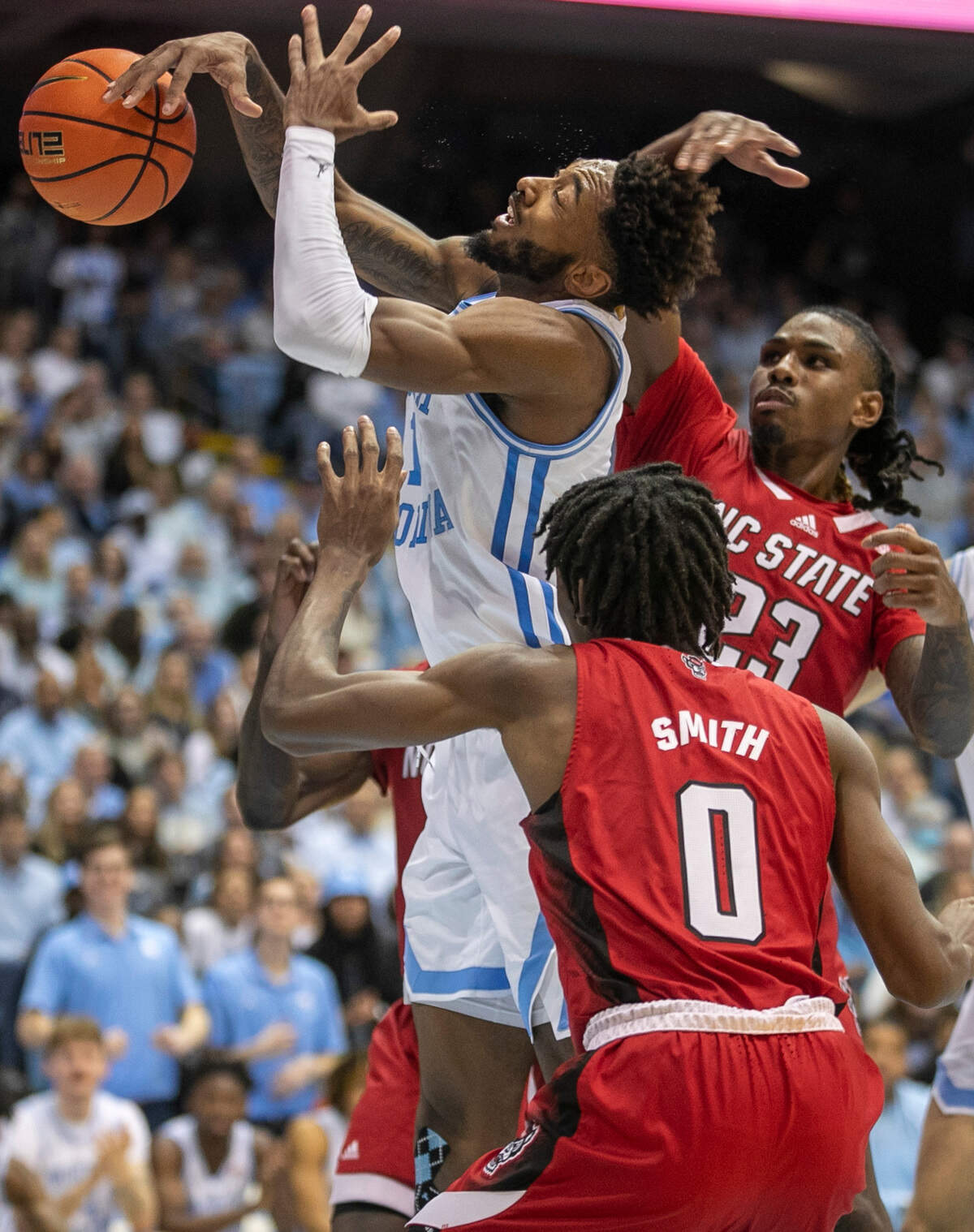N.C. State’s Greg Gantt (23) fouls North Carolina’s Leaky Black (1) during the second half on Saturday, January 21, 2023 at the Smith Center in Chapel Hill, N.C.