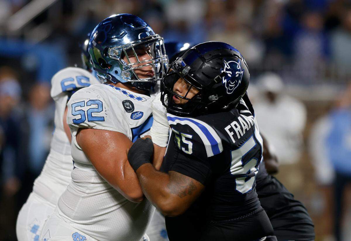 Duke Blue Devils defensive tackle Ja’Mion Franklin attempts to maneuver around North Carolina Tar Heels offensive lineman Jonathan Adorno on Saturday, Oct. 15, 2022, at Wallace Wade Stadium in Durham, N.C.
